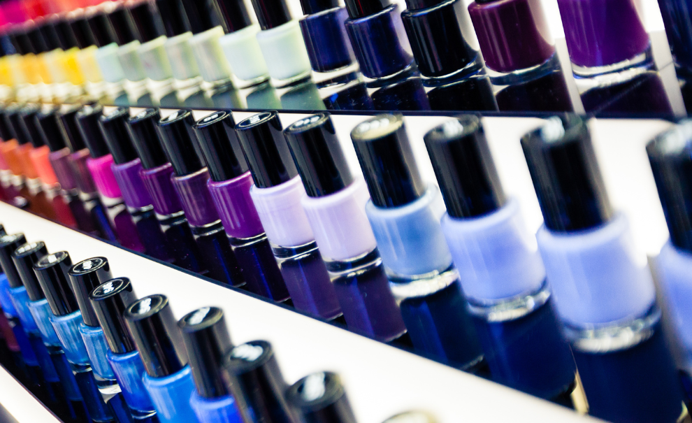 Rows of assorted nail polish bottles.